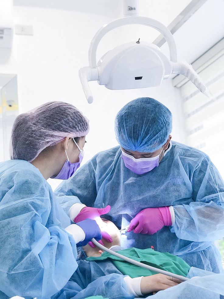 Dental team performing oral surgery